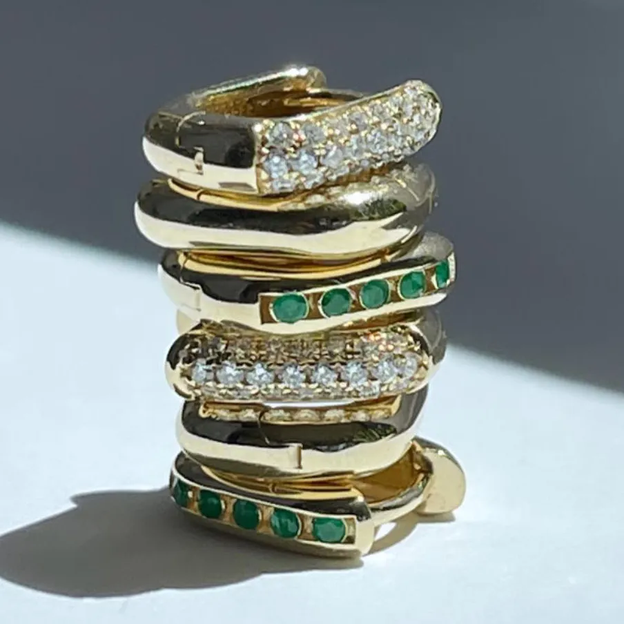 stack gold rings some with diamonds and other with emeralds