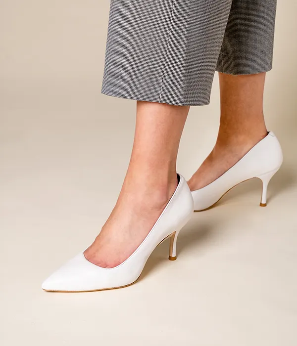 Close up photo of women's white pumps shoes